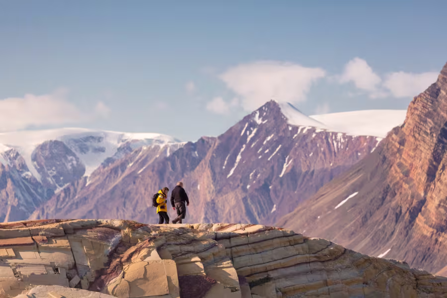 QuarkExpeditions_pax_in_landscape_skipperdal_kong_oscar_fjord_east_greenland_Credit-AcaciaJohnson